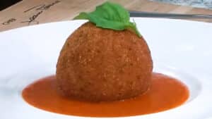 How to Make Rice Balls - Arancini Place on Bell Pepper Coulis and add Fresh Basil as garnish