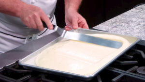 Easy Tiramisu Recipe - Spread the batter evenly onto the baking sheet.