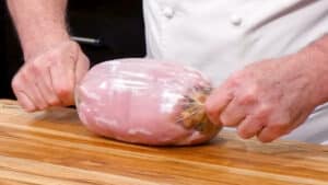 Stuffed Pork Loin Recipe - Secure the roll with the plastic wrap