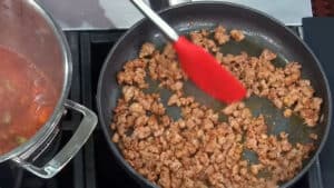 Hearty Lentil Soup Recipe - caramelizing the sausage