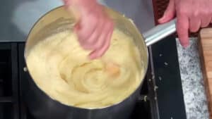 Cheesy Mashed Potatoes Recipe - Aligot Potatoes - vigorously stirring the potatoes with cheese