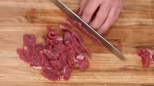 French Onion Beef Stir Fry - slicing beef into thin strips